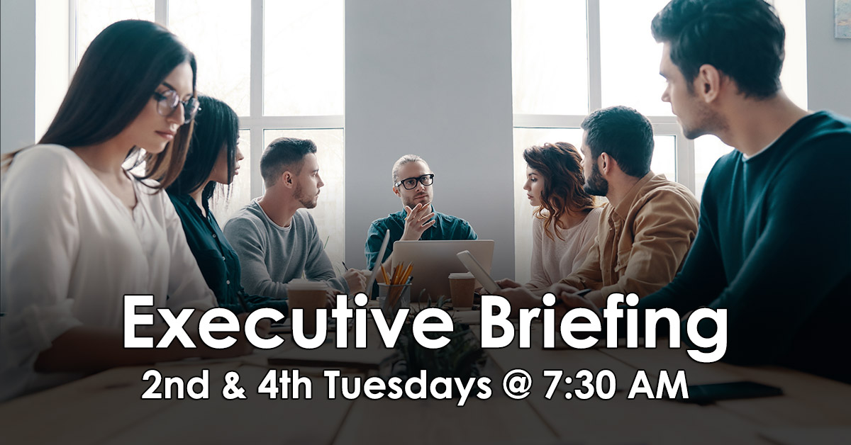 Executive Briefing the second and fourth Tuesdays at 7:30 AM. Group of people sitting in a meeting discussing business.