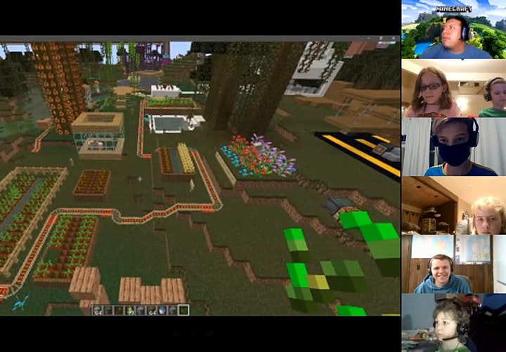Minecraft being played on Zoom. Screen shows the Minecraft environment on the left, and all the players Zoom feeds on the right.